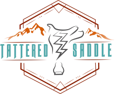 A stylized emblem featuring a central zigzag bolt with a goat skull silhouette, teal &ldquo;Jittered&rdquo; text, and orange mountain motif inside a geometric frame.